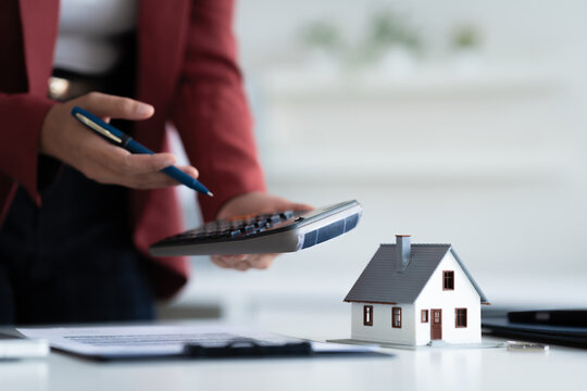 consultant calculates property valuation and house loan contract in office