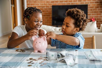 Fototapeta na wymiar Children saving money together happily.