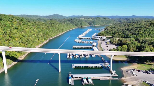 Aerial View of the Lakeside Sunset Marina Resort on Dale Hollow Lake With Highway 111 Bridge, Boats and Forested Shoreline, Calm Water on a Sunny Day, Monroe, Tennessee, USA.