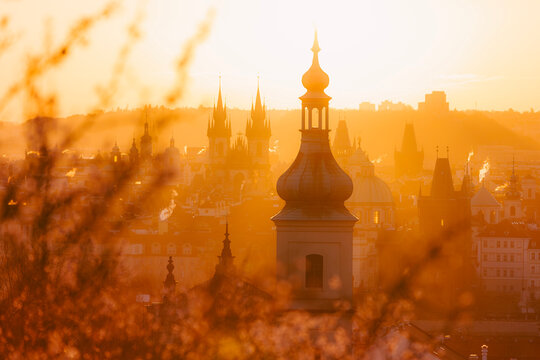 Panoramic view of Prague skyline with towers of historic city center during sunny spring morning. European architecture, travel destination, and cultural heritage concept.