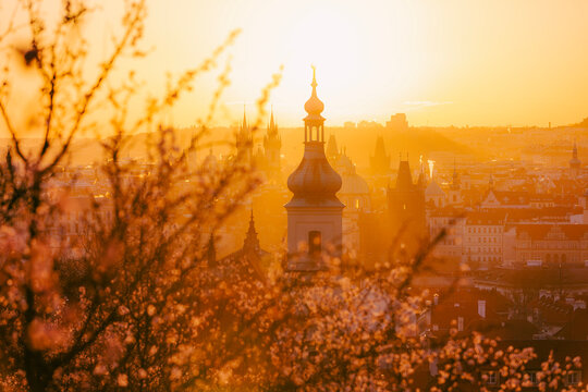 Panoramic view of Prague skyline with towers of historic city center during sunny spring morning. European architecture, travel destination, and cultural heritage concept.