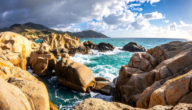 Coastal rocks and waves under a partly cloudy sky