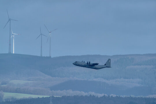 Military transport aircraft flying over landscape near Ramstein Air Base
