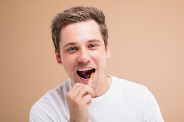 Man brushing teeth smiling