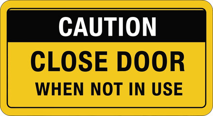 Fototapeta premium A caution sign reads Close Door When Not In Use on a yellow background
