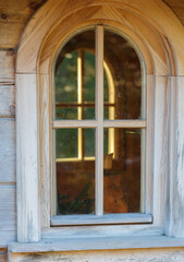 Fototapeta premium Arched wooden window cross pane rustic traditional architecture vintage weathered church religious detail