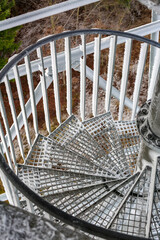 Metal spiral staircase frost frozen ice winter geometric industrial perspective looking down cold