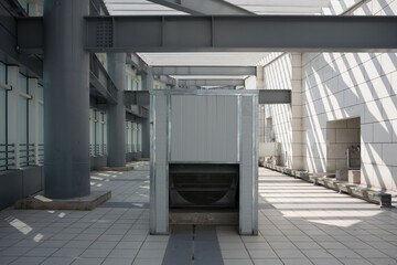 Obraz premium Large ventilation equipment installed inside an industrial factory building with metal framework and geometric lighting patterns