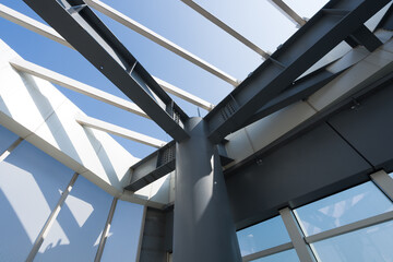 Obraz premium Modern architectural steel structure roof viewed from below with geometric beams and glass panels