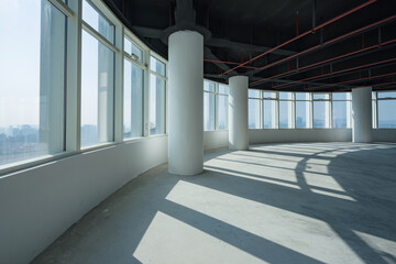 Obraz premium Spacious empty office interior with large windows and abundant natural light