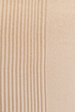 Textured sand with parallel lines.