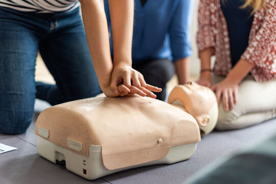 CPR training with practice mannequin.