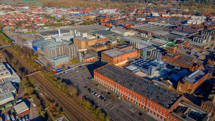 Obraz premium Historical brewery architecture with modern production facilities and railway