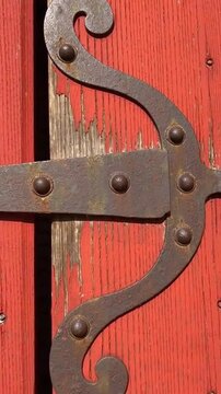 Vintage Red Wooden Door Hinge Closeup.