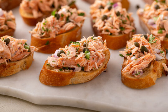 Hot smoked salmon crostini with smoked or roasted salmon, red onion and capers