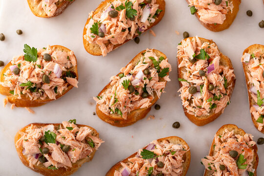 Hot smoked salmon crostini with smoked or roasted salmon, red onion and capers