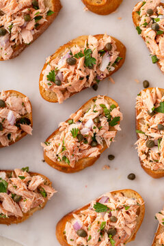 Hot smoked salmon crostini with smoked or roasted salmon, red onion and capers