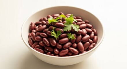 Fototapeta premium Bowl of kidney beans garnished with fresh parsley sprigs.