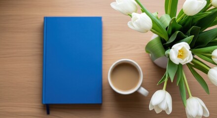 Fototapeta premium Blue book coffee and white tulips on wooden table.