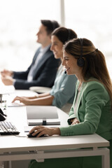 Professional staff of tech support company customer service department working in call center...