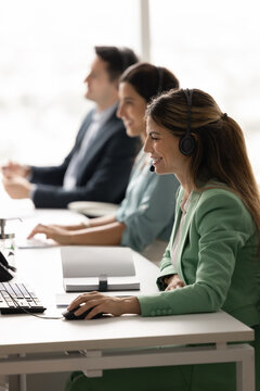 Professional staff of tech support company customer service department working in call center office contacting clients via video chat offering online assistance expert consultations. Vertical photo
