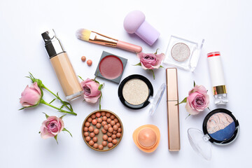 Naklejka premium Spring composition with different makeup products and pink roses on white background, flat lay