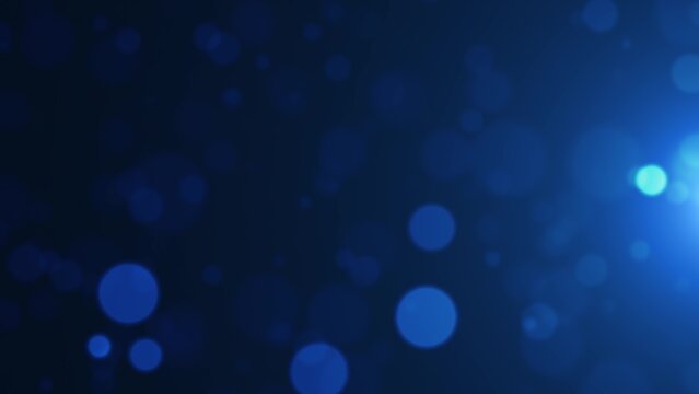 Soft blue bokeh lights floating on a dark backdrop