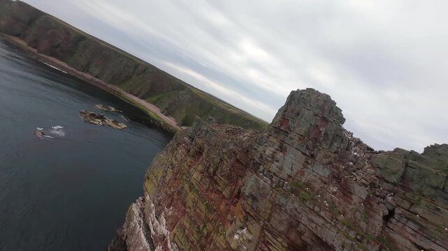 Dynamic FPV Drone Flight Close to a Sharp Rock Sea Stck in the Ocean