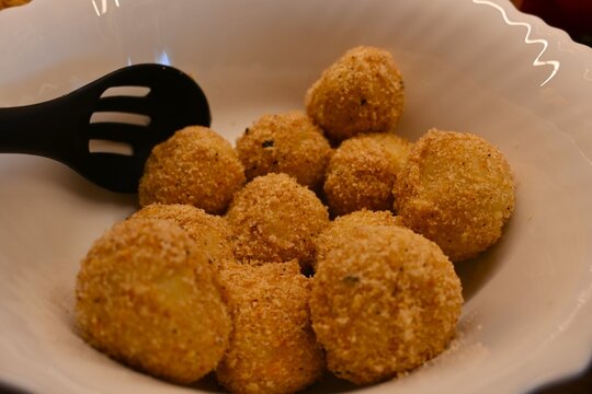 Bowl filled with traditional Hungarian plum dumplings. Classic homemade dessert representing traditional cuisine, comfort food and family cooking concepts.
