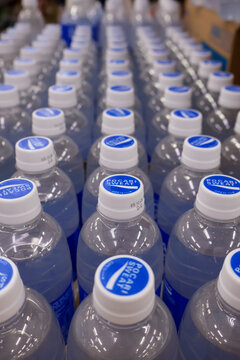 Balikpapan-Indonesia March 14, 2026 High-angle view of many Pocari sweat bottles with white and blue caps neatly arranged in a factory or retail stock, representing hydration, mass production, and hea
