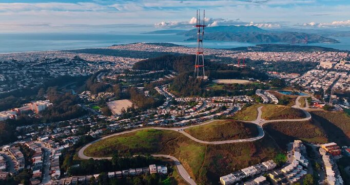 Residential area on the green hills of San Francisco, California, USA. Sutro tower for television and radio transmission in the center. Aerial view.