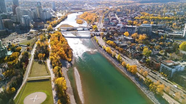 Prince's Island Park Peace Bridge autumn foliage scenery. Aerial view of Downtown City of Calgary. Alberta, Canada.