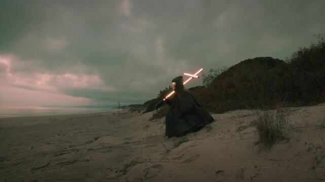 Lonely man walks on the beach carrying a cross on his shoulders
