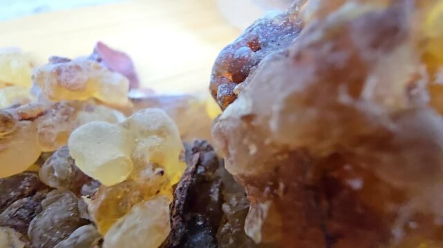 High-quality macro cinematic footage showcasing the raw, organic beauty of Frankincense resin tears (Boswellia sacra). The video highlights the intricate crystalline textures and diverse color palette