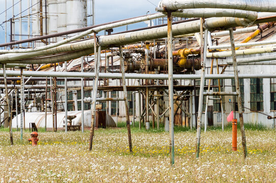 Canada, Alberta, Turner Valley.  Pipelines and rusted buildings at the Turner Valley Gas Plant, historic site.