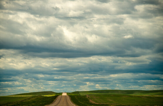Canada, southwest Saskatchewan.  Rural road through prairie farmland