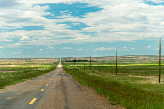 Canada, southwest Saskatchewan.  Rural road through prairie farmland