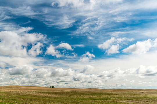 Canada, Saskatchewan, North Battleford.  Big sky over a recently harvested wheat field.