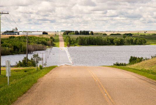 Canada, Saskatchewan, North Battleford.  Flooded road ahead in a low point in the prairie landscape.