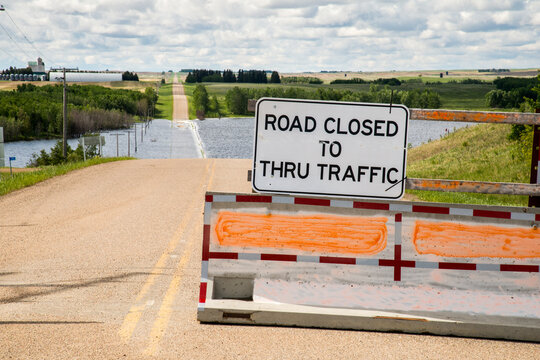 Canada, Saskatchewan, North Battleford.  Flooded road ahead in a low point in the prairie landscape.