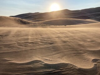 Sand cascades at Great Sand Dunes National Park, Colorado over rippled dunes at sunset Sunset at Great Sand Dunes National Park, Colorado, USA © Elaine