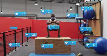 Squatting man wearing white sleeveless top and cloth mask on plyometric box at gym, social overlays © vectorfusionart