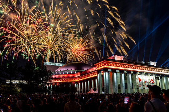 Salut over Opera and ballet theatre building with lightening at night on occasion of may 9 victory day on Lenin square with a lot of people. Novosibirsk, Russia-9 May 2025