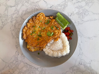 Thai Minced Pork Omelet over Rice. It’s the perfect quick meal, crispy, savory, and so satisfying. A true local favorite