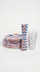 Obraz premium Stack of patriotic red white and blue paper plates straws and star cups. Disposable tableware for summer kickoff or Memorial Day celebration