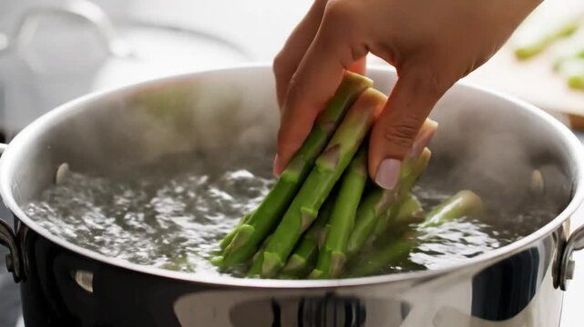 Blanching fresh asparagus in boiling water, a cooking demonstration of how to prepare the vegetable