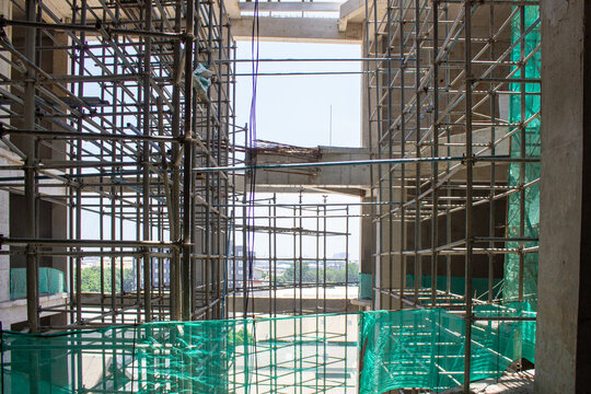 Jakarta, Indonesia - March 16, 2026: Steel scaffolding frame on a commercial building project showing concrete building structure progress.