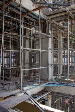 Jakarta, Indonesia - March 16, 2026: Metal construction scaffolding of a high-rise building with concrete pillars at a construction site in Jakarta
