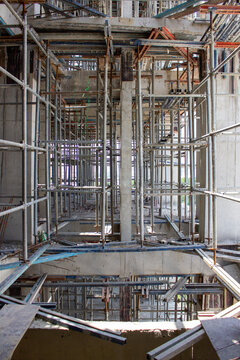 Jakarta, Indonesia - March 16, 2026: Complex metal scaffolding structure surrounding concrete pillars in a high-rise building project in Jakarta