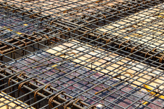 Steel rebar grid framework for concrete floor slab casting at a building construction site